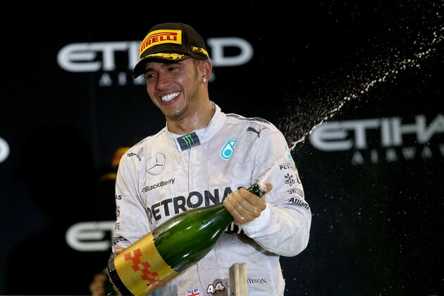 ABU DHABI, UNITED ARAB EMIRATES - NOVEMBER 23:  Lewis Hamilton of Great Britain and Mercedes GP celebrates on the podium after winning the World Championship and the Abu Dhabi Formula One Grand Prix at Yas Marina Circuit on November 23, 2014 in Abu Dhabi, United Arab Emirates.  (Photo by Clive Rose/Getty Images)