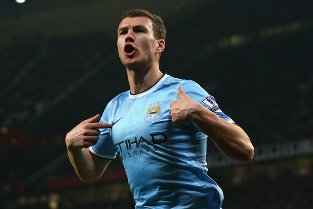 MANCHESTER, ENGLAND - MARCH 25:  Edin Dzeko of Manchester City celebrates scoring the second goal during the Barclays Premier League match between Manchester United and Manchester City at Old Trafford on March 25, 2014 in Manchester, England.  (Photo by Alex Livesey/Getty Images)