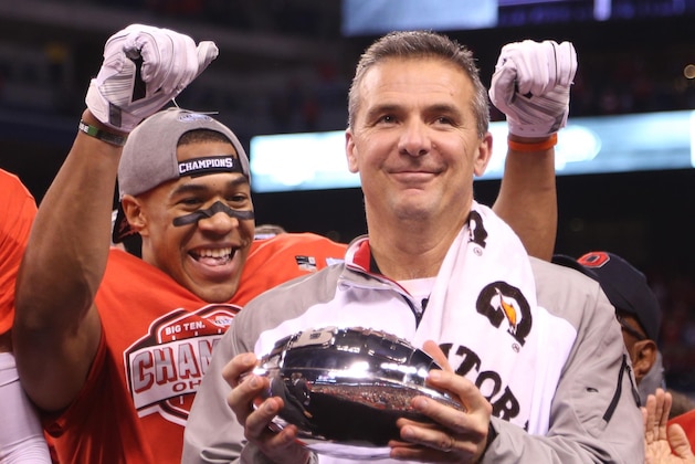 Dec 6, 2014; Indianapolis, IN, USA; Ohio State Buckeyes coach Urban Meyer holds the trophy after defeating the Wisconsin Badgers in the Big Ten football championship game at Lucas Oil Stadium. Ohio State defeats Wisconsin 59-0. Mandatory Credit: Brian Spurlock-USA TODAY Sports