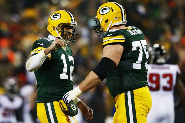 GREEN BAY, WI - DECEMBER 08:  Aaron Rodgers #12 and Bryan Bulaga #75 of the Green Bay Packers celebrate a touchdown by  Eddie Lacy #27 in the second quarter against the Atlanta Falcons at Lambeau Field on December 8, 2014 in Green Bay, Wisconsin.  (Photo by Kevin C. Cox/Getty Images)