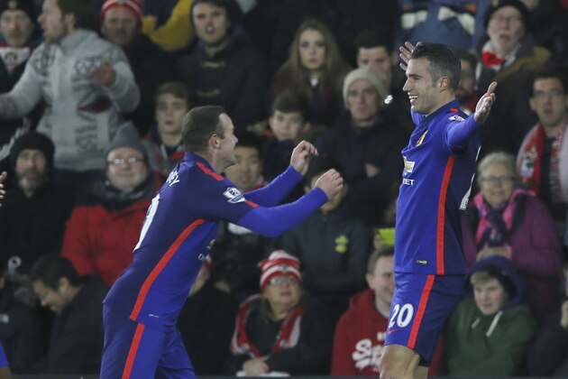 Manchester United’s Robin Van Persie, right, celebrates with teammates after scoring the opening goal of the game during their English Premier League soccer match between Southampton and Manchester United at St Mary's stadium in Southampton, England, Monday, Dec. 8, 2014. (AP Photo/Alastair Grant)