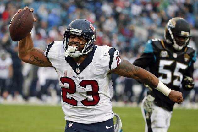 Houston Texans running back Arian Foster (23) reacts in the end zone near Jacksonville Jaguars outside linebacker Geno Hayes (55) after running for a 1-yard touchdown during the second half of an NFL football game in Jacksonville, Fla., Sunday, Dec. 7, 2014. (AP Photo/Stephen B. Morton)