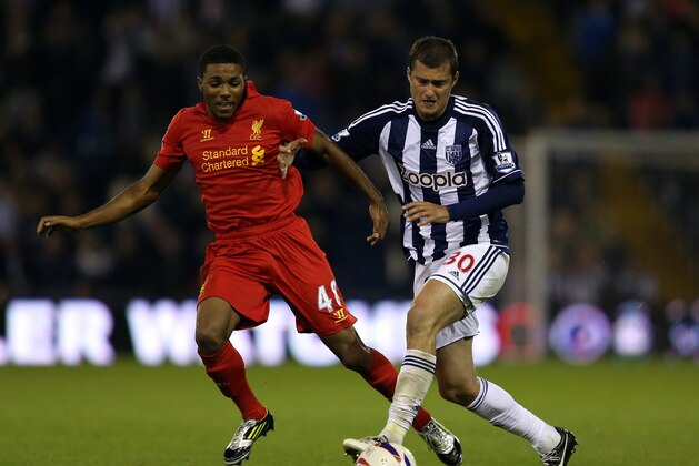 WEST BROMWICH, ENGLAND - SEPTEMBER 26:  Jerome Sinclair of Liverpool battles with Gabriel Tamas of West Brom during the Capital One Cup third round match between West Bromwich Albion and Liverpool at The Hawthorns on September 26, 2012 in West Bromwich, England.  (Photo by Richard Heathcote/Getty Images)