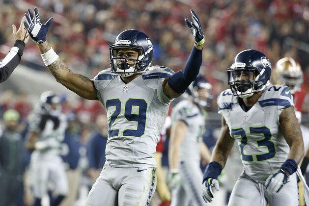 Seattle Seahawks free safety Earl Thomas (29) celebrates with strong safety Jeron Johnson (23) during the fourth quarter of an NFL football game against the San Francisco 49ers in Santa Clara, Calif., Thursday, Nov. 27, 2014. (AP Photo/Tony Avelar)