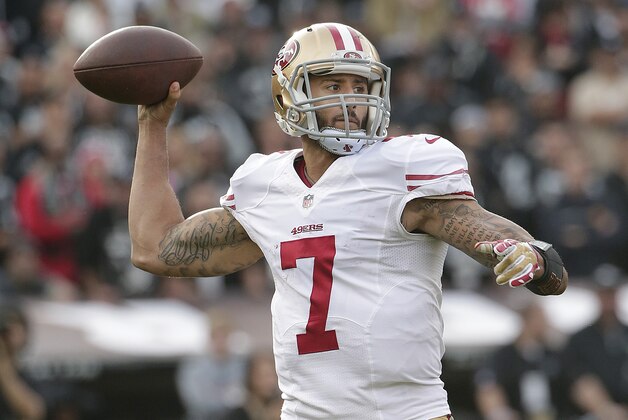 San Francisco 49ers quarterback Colin Kaepernick (7) passes against the Oakland Raiders during the second quarter of an NFL football game in Oakland, Calif., Sunday, Dec. 7, 2014. (AP Photo/Marcio Jose Sanchez)