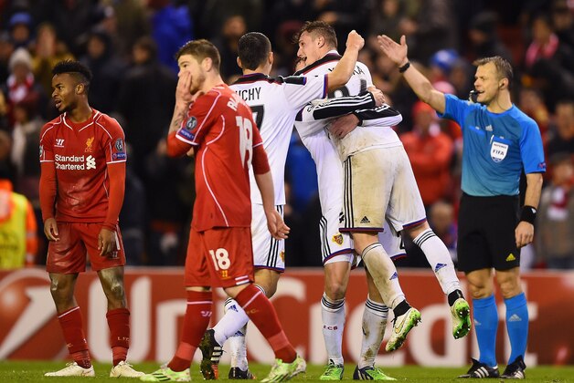 LIVERPOOL, ENGLAND - DECEMBER 09:  Basel players celebrate their team's 1-1 draw as the final whistle blows during the UEFA Champions League group B match between Liverpool and FC Basel 1893 at Anfield on December 9, 2014 in Liverpool, United Kingdom.  (Photo by Laurence Griffiths/Getty Images)