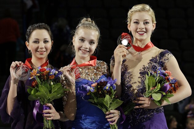 Gold medalist Elena Radionova, center, of Russia, silver medalist Elizaveta Tuktamysheva, left, of Russia, and bronze medalist Gracie Gold pose for photographers with their medals for the ladies skating program at the Skate America figure skating event at the Skate America figure skating event Sunday, Oct. 26, 2014, in Hoffman Estates, Ill. (AP Photo/Nam Y. Huh)