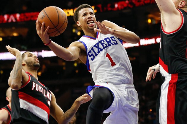 Nov 24, 2014; Philadelphia, PA, USA; Philadelphia 76ers guard Michael Carter-Williams (1) goes up for a shot past Portland Trail Blazers center Chris Kaman (35) during the second half at the Wells Fargo Center. The Trail Blazers defeated the 76ers 114-104. Mandatory Credit: Bill Streicher-USA TODAY Sports
