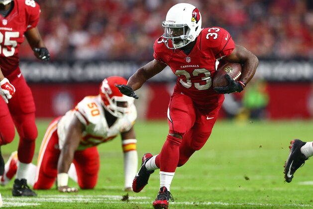Dec 7, 2014; Glendale, AZ, USA; Arizona Cardinals running back Kerwynn Williams (33) runs the ball against the Kansas City Chiefs at University of Phoenix Stadium. The Cardinals defeated the Chiefs 17-14. Mandatory Credit: Mark J. Rebilas-USA TODAY Sports