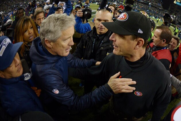 Jan 19, 2014; Seattle, WA, USA; Seattle Seahawks head coach Pete Carroll (left) shakes hands with San Francisco 49ers head coach Jim Harbaugh (right) after the 2013 NFC Championship football game at CenturyLink Field. Mandatory Credit: Kirby Lee-USA TODAY Sports