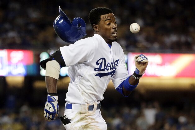 10ThingstoSeeSports - Los Angeles Dodgers' Dee Gordon runs to first base with the throw during the 10th inning of a baseball game against the San Francisco Giants, Monday, Sept. 22, 2014, in Los Angeles. Gordon was out at first. (AP Photo/Jae C. Hong, File)