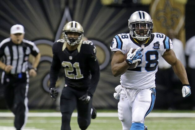 Carolina Panthers running back Jonathan Stewart (28) runs on a 69-yard touchdown carry as New Orleans Saints cornerback Patrick Robinson (21) pursues in the second half of an NFL football game in New Orleans, Sunday, Dec. 7, 2014. (AP Photo/Bill Feig)