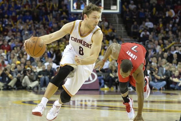 Dec 9, 2014; Cleveland, OH, USA; Cleveland Cavaliers guard Matthew Dellavedova (8) dribbles the ball past Toronto Raptors guard Kyle Lowry (7) in the fourth quarter at Quicken Loans Arena. Mandatory Credit: David Richard-USA TODAY Sports