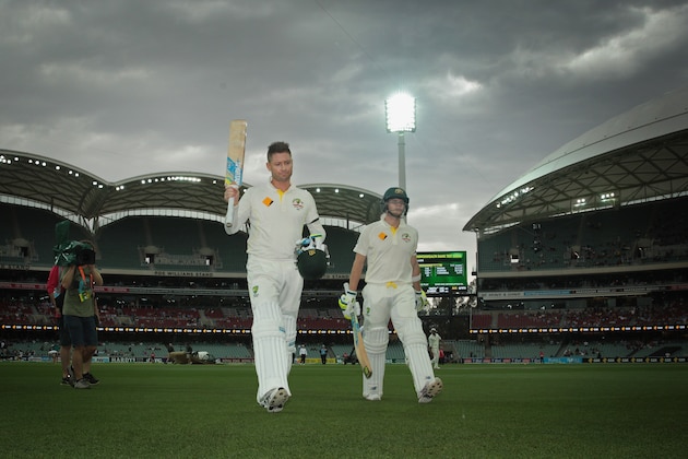 ADELAIDE, AUSTRALIA - DECEMBER 10:  Michael Clarke of Australia and Steven Smith leave the field for a rain delay after Clarke reached his century during day two of the First Test match between Australia and India at Adelaide Oval on December 10, 2014 in Adelaide, Australia.  (Photo by Scott Barbour/Getty Images)