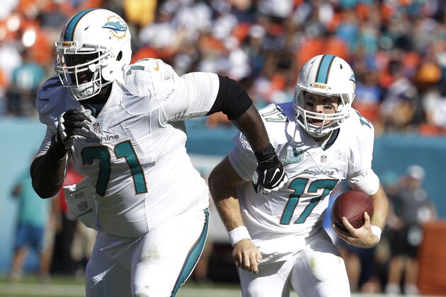 Miami Dolphins quarterback Ryan Tannehill (17) runs the ball as tackle Branden Albert (71) defends, during the first half of an NFL football game against the San Diego Chargers, Sunday, Nov. 2, 2014, in Miami Gardens, Fla.  (AP Photo/Lynne Sladky)