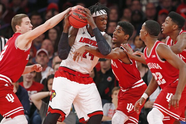 Indiana guard Nick Zeisloft (2) tries to strip the ball from Louisville forward Montrezl Harrell (24) as other Indiana defenders surround him in the second half of an NCAA college basketball game at Madison Square Garden in New York, Tuesday, Dec. 9, 2014. (AP Photo/Kathy Willens)