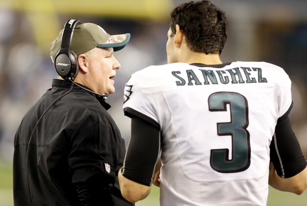 Nov 27, 2014; Arlington, TX, USA; Philadelphia Eagles head coach Chip Kelly talks with quarterback Mark Sanchez (3) on the sidelines during the game against the Dallas Cowboys at AT&T Stadium. Philadelphia beat Dallas 33-10. Mandatory Credit: Tim Heitman-USA TODAY Sports