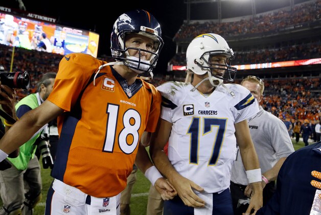 Denver Broncos quarterback Peyton Manning (18) greets San Diego Chargers quarterback Philip Rivers (17) after an NFL football game, Thursday, Oct. 23, 2014, in Denver. The Broncos won 35-21. (AP Photo/Jack Dempsey)