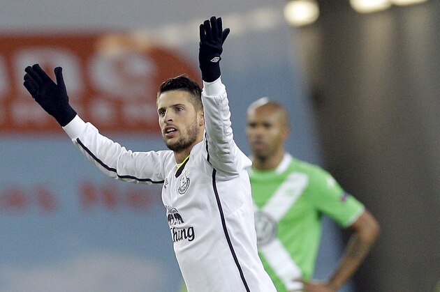 Everton's Kevin Mirallas celebrates scoring his side's 2nd goal during the Europa League Group H soccer match between VfL Wolfsburg and Everton FC at the Volkswagen Arena stadium in Wolfsburg, Germany, Thursday, Nov. 27, 2014. In the background is Wolfsburg's Naldo. (AP Photo/Michael Sohn)