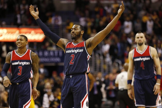 Dec 3, 2014; Washington, DC, USA; Washington Wizards guard John Wall (2) celebrates in front of Wizards guard Bradley Beal (3) and Wizards center Marcin Gortat (4) against the Los Angeles Lakers in the fourth quarter at Verizon Center. The Wizards won 111-95. Mandatory Credit: Geoff Burke-USA TODAY Sports