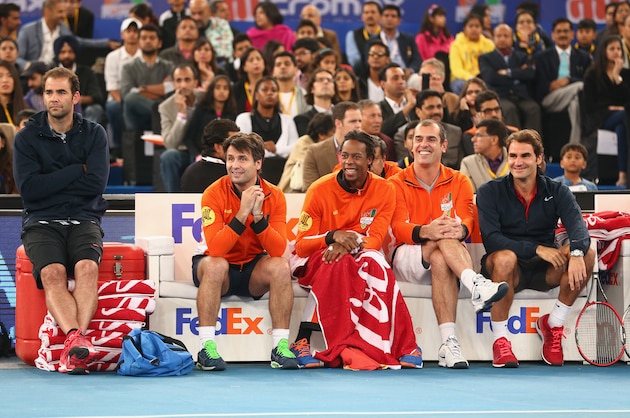 DELHI, INDIA - DECEMBER 08:  L-R Pete Sampras,Fabrice Santoro,Gael monfils,Cedric Pioline and Roger Federer of the Indian Aces watch as their team plays against the UAE Royals during the Coca-Cola International Premier Tennis League third leg at the Indira Gandhi Indoor Stadium December 8, 2014 in Delhi, Delhi.  (Photo by Clive Brunskill/Getty Images for IPTL 2014)