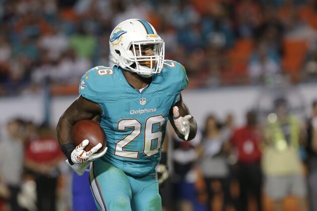 Miami Dolphins running back Lamar Miller runs for yardage during the second half of an NFL football game against the Buffalo Bills, Thursday, Nov. 13, 2014 in Miami Gardens, Fla. The Dolphins defeated the Bills 22-9. (AP Photo/Alan Diaz)