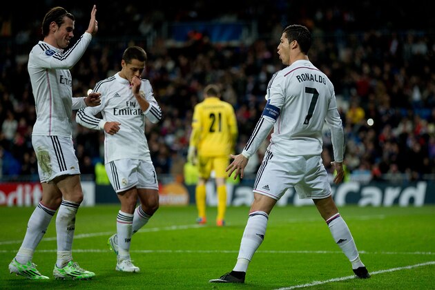 MADRID, SPAIN - DECEMBER 09: Cristiano Ronaldo (R) of Real Madrid CF celebrates scoring their opening goal with team-mates Gareth Bale (L) and Javier Hernandez Chicharito (2ndL) during the UEFA Champions League Group B match between Real Madrid CF and PFC Ludogorets Razgrad at Estadio Santiago Bernabeu on December 9, 2014 in Madrid, Spain.  (Photo by Gonzalo Arroyo Moreno/Getty Images)