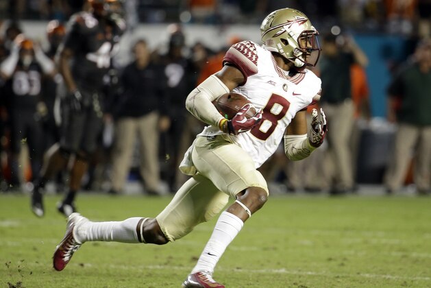 Florida State defensive back Jalen Ramsey runs with the ball after intercepting a pass thrown by Miami  quarterback Brad Kaaya in the second half an NCAA college football game, Saturday, Nov. 15, 2014, in Miami Gardens, Fla. Florida State defeated Miami 30-26. (AP Photo/Lynne Sladky)