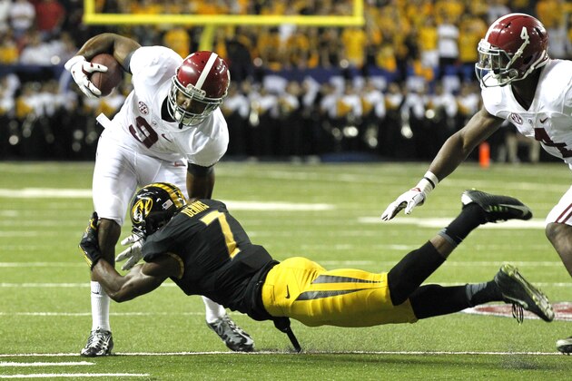 Alabama wide receiver Amari Cooper (9) is tackled by Missouri defensive back Kenya Dennis during the first half of an NCAA college football game Saturday, Dec. 6, 2014, in Atlanta, Ga. (AP Photo/Butch Dill)