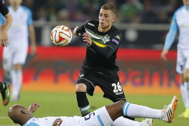 Moenchengladbach's Thorgan Hazard, rear, and Apollon’s Joao Paulo Andrade challenge for the ball during the Europa League group A soccer match between  Borussia Moenchengladbach and Apollon in Moenchengladbach, Germany, Thursday, Oct. 23, 2014 . (AP Photo/Frank Augstein)