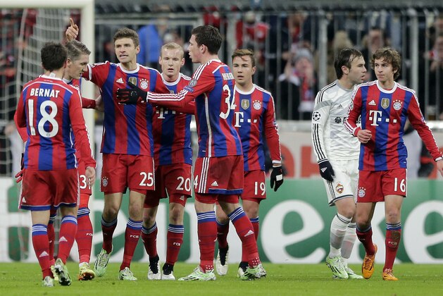 Bayern's Thomas Mueller, third left, celebrates with his teammates after scoring his side's first goal during the Champions League group E soccer match between FC Bayern Munich and CSKA Moscow in Munich, Germany, Wednesday, Dec. 10, 2014. (AP Photo/Matthias Schrader)