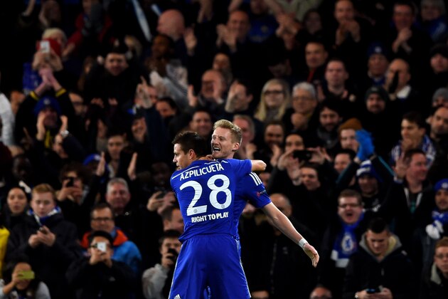 LONDON, ENGLAND - DECEMBER 10:  Andre Schuerrle of Chelsea celebrates with teammate Cesar Azpilicueta #28 of Chelsea after scoring his team's second goal during the UEFA Champions League group G match between Chelsea and Sporting Clube de Portugal at Stamford Bridge on December 10, 2014 in London, United Kingdom.  (Photo by Paul Gilham/Getty Images)