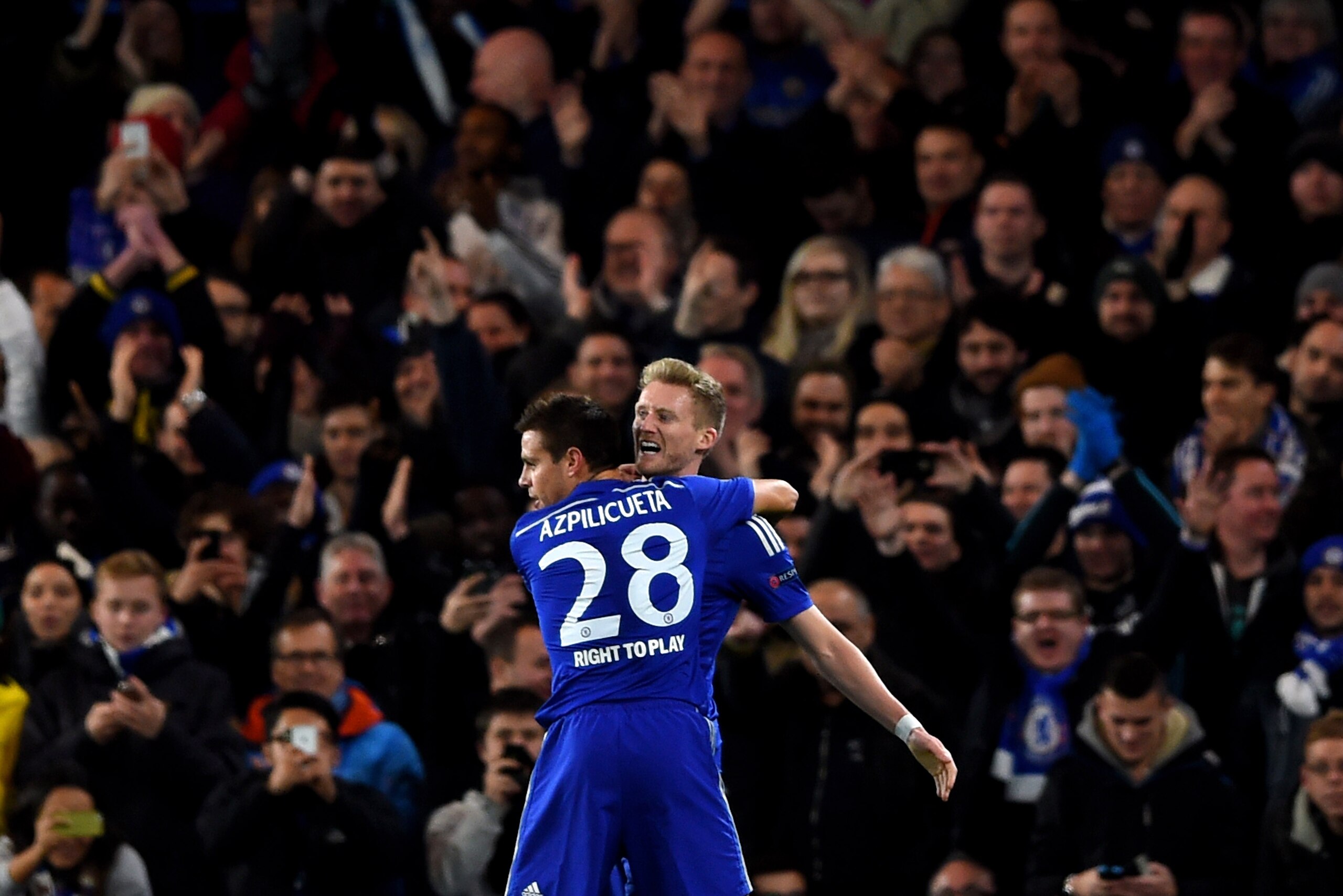 LONDON, ENGLAND - DECEMBER 10:  Andre Schuerrle of Chelsea celebrates with teammate Cesar Azpilicueta #28 of Chelsea after scoring his team's second goal during the UEFA Champions League group G match between Chelsea and Sporting Clube de Portugal at Stamford Bridge on December 10, 2014 in London, United Kingdom.  (Photo by Paul Gilham/Getty Images)