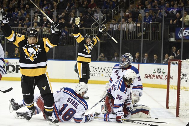 Pittsburgh Penguins right wing Steve Downie (23) and center Sidney Crosby (87) celebrate Downie's goal as New York Rangers defenseman Marc Staal (18), Mats Zuccarello (36) and New York Rangers goalie Henrik Lundqvist (30) react in the third period of an NHL hockey game at Madison Square Garden on Monday, Dec. 8, 2014, in New York. The Rangers won 4-3 in overtime. (AP Photo/Kathy Kmonicek)
