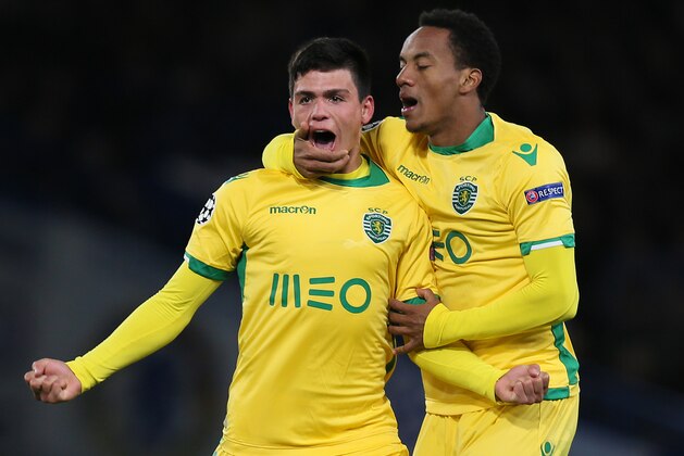Sporting’s Jonathan Silva, left, celebrates scoring a goal with teammate Andre Carrillo during the Champions League Group G soccer match between Chelsea and Sporting Lisbon at Stamford Bridge in London, Wednesday, Dec. 10, 2014. (AP Photo/Tim Ireland)