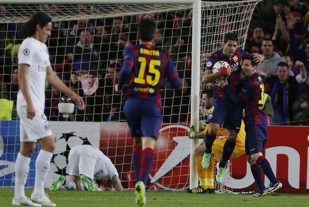 Barcelona's Lionel Messi, right, and his teammate Luis Suarez celebrate the first goal of their team during a Group F Champions League soccer match between FC Barcelona and PSG at the Camp Nou stadium in Barcelona, Spain, Wednesday Dec. 10, 2014. (AP Photo/Emilio Morenatti)