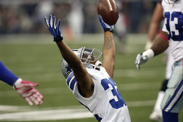 Dallas Cowboys cornerback Orlando Scandrick (32) celebrates intercepting a Houston Texans quarterback Ryan Fitzpatrick pass during the first half of an NFL football game, Sunday, Oct. 5, 2014, in Arlington, Texas. (AP Photo/Brandon Wade)