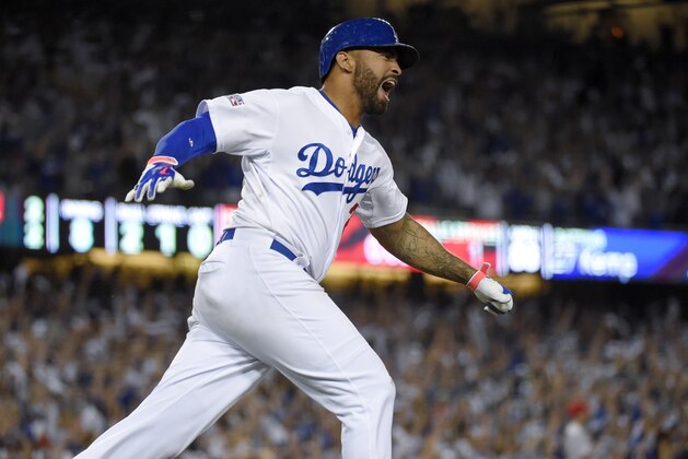Los Angeles Dodgers' Matt Kemp celebrates his home run against the St. Louis Cardinals during the eighth inning in Game 2 of baseball's NL Division Series in Los Angeles, Saturday, Oct. 4, 2014. (AP Photo/Mark J. Terrill)