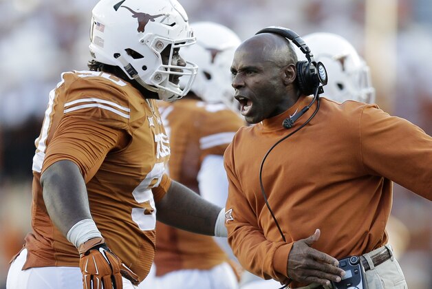 Texas Longhorns head coach Charlie Strong, right, celebrates with Malcom Brown, left, during the second half of an NCAA college football game against West Virginia, Saturday, Nov. 8, 2014, in Austin, Texas.  Texas won 33-16. (AP Photo/Eric Gay)