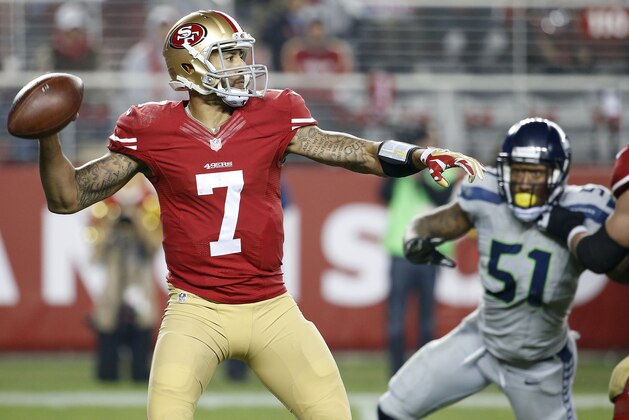 San Francisco 49ers quarterback Colin Kaepernick (7) passes against the Seattle Seahawks during the fourth quarter of an NFL football game in Santa Clara, Calif., Thursday, Nov. 27, 2014. (AP Photo/Tony Avelar)