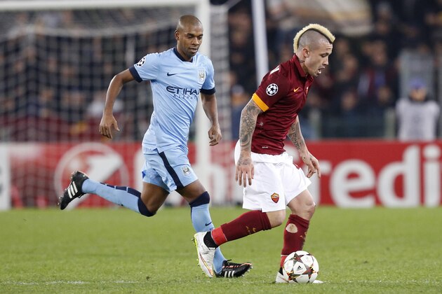 Manchester City's Fernando, left, and Roma's Radja Nainggolan vie for the ball  during a Group E Champions League soccer match between Roma and Manchester City at the Olympic stadium in Rome, Italy, Wednesday Dec.10, 2014. (AP Photo/Riccardo De Luca)