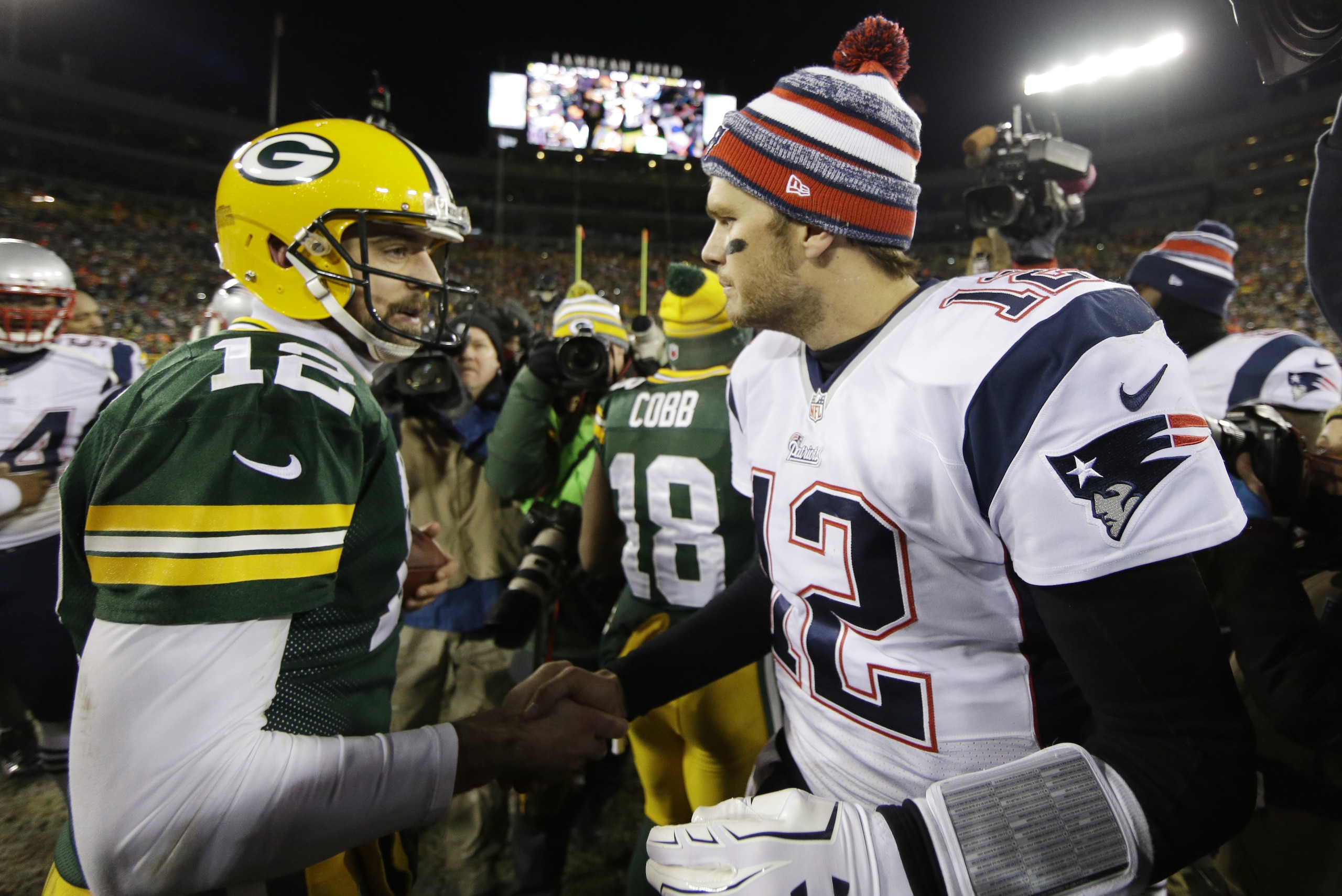 Green Bay Packers' Aaron Rodgers shakes hands with New England Patriots' Tom Brady after an NFL football game Sunday, Nov. 30, 2014, in Green Bay, Wis. The Packers won 26-21. (AP Photo/Tom Lynn)