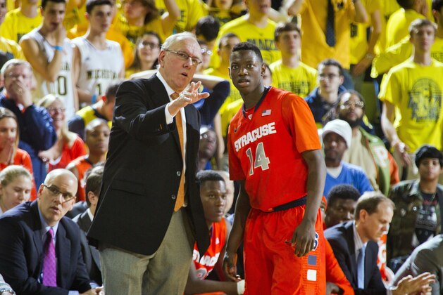 Syracuse head coach Jim Boeheim, left, gives instruction to Syracuse guard Kaleb Joseph (14) in the second half of an NCAA college basketball game against Michigan at Crisler Center in Ann Arbor, Mich., Tuesday, Dec. 2, 2014. Michigan won 68-65. (AP Photo/Tony Ding)