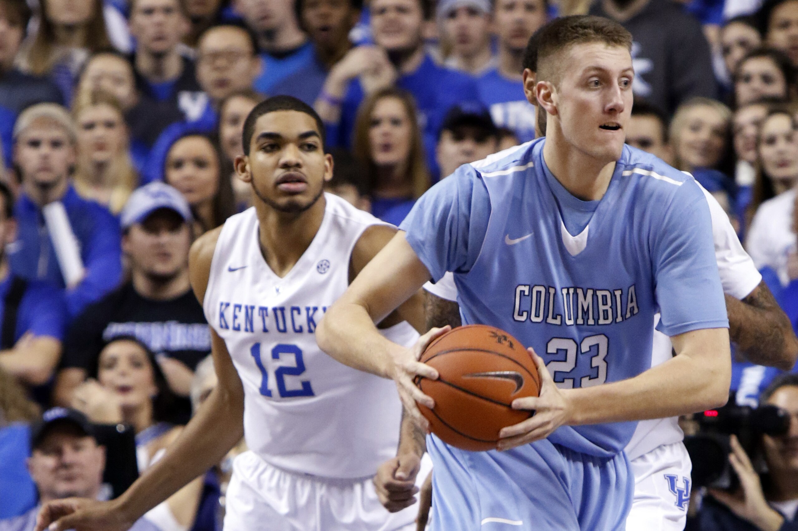 Columbia's Cory Osetkowski (23) looks for an open teammate near Kentucky's Karl-Anthony Towns (12) during the first half of an NCAA college basketball game, Wednesday, Dec. 10, 2014. (AP Photo/James Crisp)