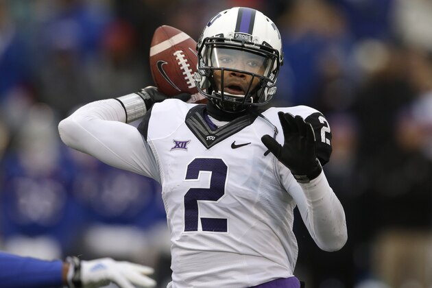 FILE - In this Nov. 15, 2014, file photo, TCU quarterback Trevone Boykin (2) passes to a teammate during the first half of an NCAA college football game against Kansas in Lawrence, Kan. Boykin, the only TCU player ever with a 200-yard passing game, 100-yard receiving game and 100-yard rushing game in the same season is now focused only on being the quarterback in TCU's new up-tempo offense, with the No. 5 Horned Frogs in playoff contention and him in the Heisman conversation. (AP Photo/Orlin Wagner, File)