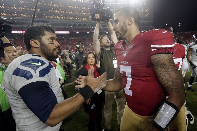 Seattle Seahawks quarterback Russell Wilson (3) shakes hands with San Francisco 49ers quarterback Colin Kaepernick (7) after an NFL football game in Santa Clara, Calif., Thursday, Nov. 27, 2014. The Seahawks won 19-3. (AP Photo/Marcio Jose Sanchez)