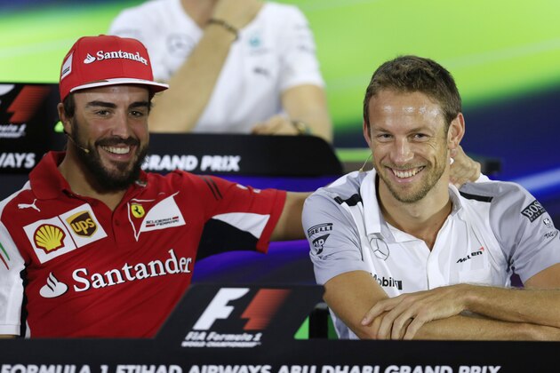 Ferrari driver Fernando Alonso of Spain, left, and McLaren Mercedes driver Jenson Button of Britain share a lighter moment during a news conference at the Yas Marina racetrack in Abu Dhabi, United Arab Emirates, Thursday, Nov. 20, 2014. With double points on offer in the Formula One finale, there could yet be a bitter twist to the fascinating title duel between Mercedes teammates Lewis Hamilton and Nico Rosberg at the Abu Dhabi Grand Prix. The Emirates Formula One Grand Prix will take place on Sunday. (AP Photo/Hassan Ammar)