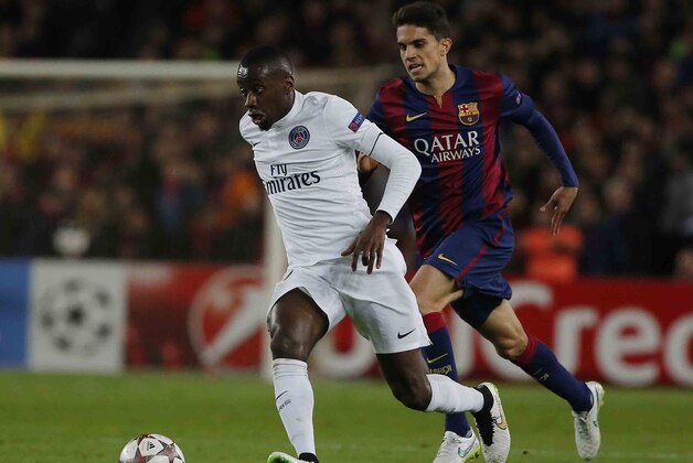 Barcelona's Marc Bartra, right, tries to stop PSG's Blaise Matuidi during a Group F Champions League soccer match between FC Barcelona and PSG at the Camp Nou stadium in Barcelona, Spain, Wednesday Dec. 10, 2014. (AP Photo/Emilio Morenatti)