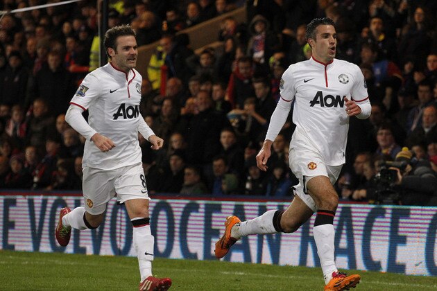 Manchester United's Robin Van Persie, right, celebrates his penalty goal against Crystal Palace with teammate Juan Mata during their English Premier League soccer match at Selhurst Park, London, Saturday, Feb. 22, 2014. (AP Photo/Sang Tan)