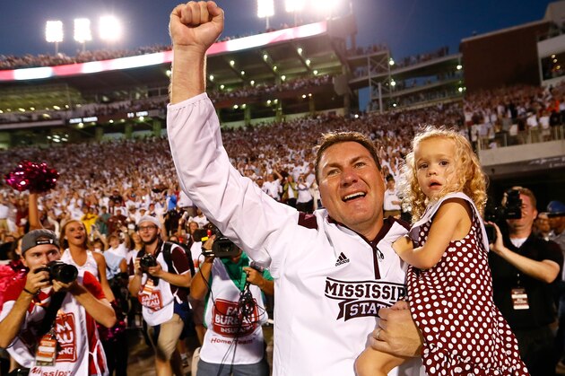 STARKVILLE, MS - OCTOBER 11:  Head coach Dan Mullen of the Mississippi State Bulldogs celebrates their 38-23 win over the Auburn Tigers with daughter Breelyn at Davis Wade Stadium on October 11, 2014 in Starkville, Mississippi.  (Photo by Kevin C. Cox/Getty Images)